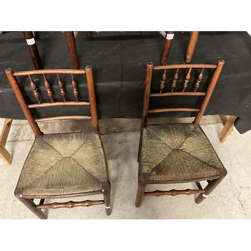 275 - 5 EARLY VICTORIAN OAK DINING CHAIRS WITH SPINDLE DECORATION AND WOVEN SEATS TO INCLUDE 1 CARVER A/F