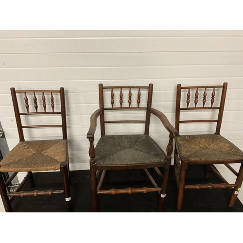 275 - 5 EARLY VICTORIAN OAK DINING CHAIRS WITH SPINDLE DECORATION AND WOVEN SEATS TO INCLUDE 1 CARVER A/F