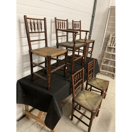 275 - 5 EARLY VICTORIAN OAK DINING CHAIRS WITH SPINDLE DECORATION AND WOVEN SEATS TO INCLUDE 1 CARVER A/F