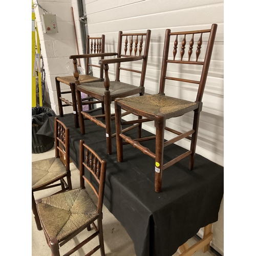 275 - 5 EARLY VICTORIAN OAK DINING CHAIRS WITH SPINDLE DECORATION AND WOVEN SEATS TO INCLUDE 1 CARVER A/F