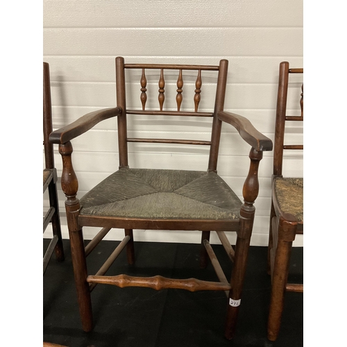 275 - 5 EARLY VICTORIAN OAK DINING CHAIRS WITH SPINDLE DECORATION AND WOVEN SEATS TO INCLUDE 1 CARVER A/F