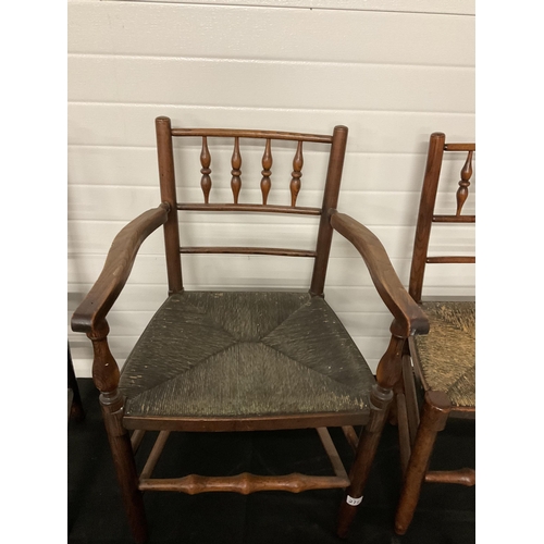 275 - 5 EARLY VICTORIAN OAK DINING CHAIRS WITH SPINDLE DECORATION AND WOVEN SEATS TO INCLUDE 1 CARVER A/F