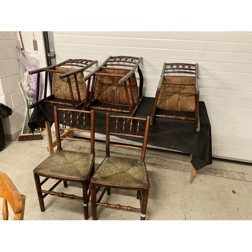 275 - 5 EARLY VICTORIAN OAK DINING CHAIRS WITH SPINDLE DECORATION AND WOVEN SEATS TO INCLUDE 1 CARVER A/F