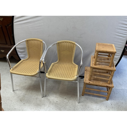 485 - 2 METAL FRAMED WOVEN CHAIRS AND A CANE NEST OF TABLES