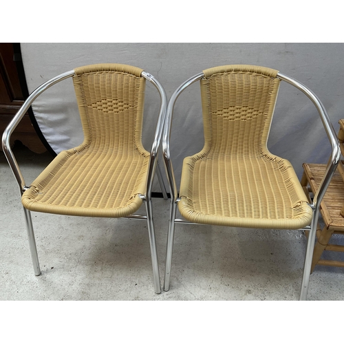 485 - 2 METAL FRAMED WOVEN CHAIRS AND A CANE NEST OF TABLES