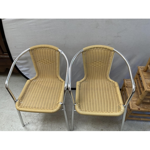 485 - 2 METAL FRAMED WOVEN CHAIRS AND A CANE NEST OF TABLES