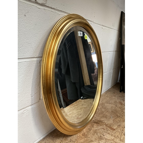 56 - MODERN OVAL GILT FRAMED MIRROR  28