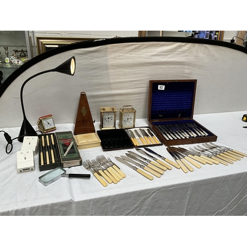 62 - BOX OF ODDS TO INCLUDE ANGLE POISE LAMP, MANTLE CLOCKS, CUTLERY AND METRONOME