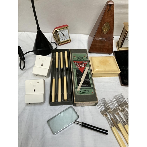 62 - BOX OF ODDS TO INCLUDE ANGLE POISE LAMP, MANTLE CLOCKS, CUTLERY AND METRONOME