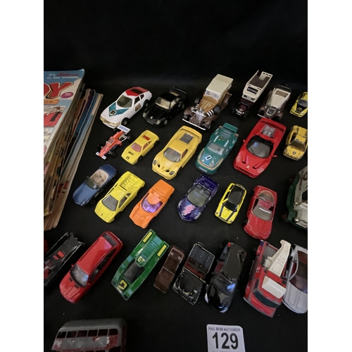 129 - CRATE OF TOY CARS AND A QTY OF COMICS