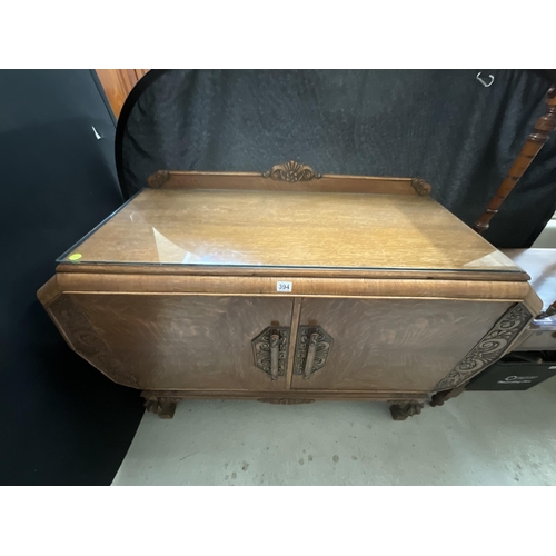 394 - ART DECO OAK SIDEBOARD WITH 2 DOORS CARVED DECORATION ON STRETCHERED BASE WITH FITTED INTERIOR H39