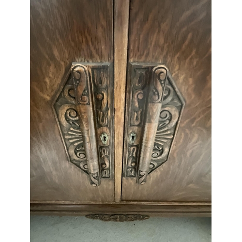 394 - ART DECO OAK SIDEBOARD WITH 2 DOORS CARVED DECORATION ON STRETCHERED BASE WITH FITTED INTERIOR H39