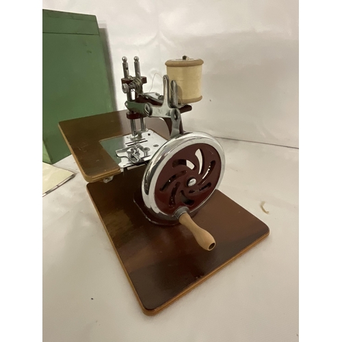 114 - CASED MINIATURE SEWING MACHINE