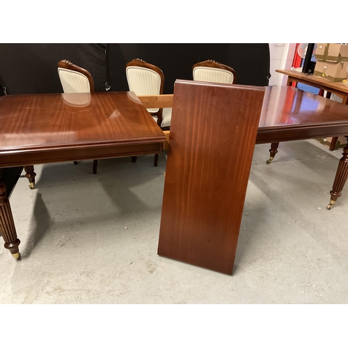 358 - REPRODUCTION MAHOGANY PULL OUT DINING TABLE WITH 1 LEAF ON REEDED LEGS AND BRASS CASTORS AND 6 MATCH... 