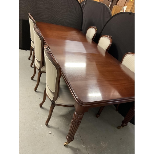 358 - REPRODUCTION MAHOGANY PULL OUT DINING TABLE WITH 1 LEAF ON REEDED LEGS AND BRASS CASTORS AND 6 MATCH... 