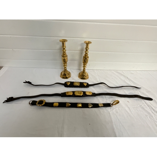 23 - PAIR OF BRASS CANDLE STICKS AND THREE MARTINGALES