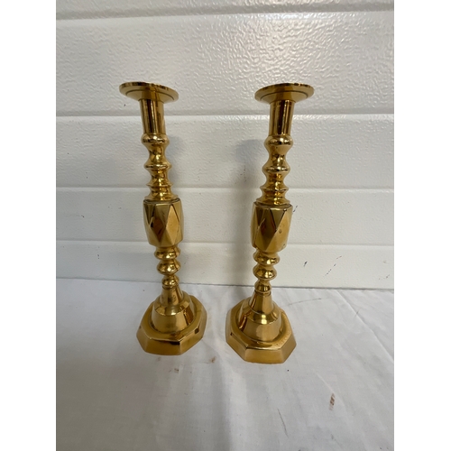 23 - PAIR OF BRASS CANDLE STICKS AND THREE MARTINGALES