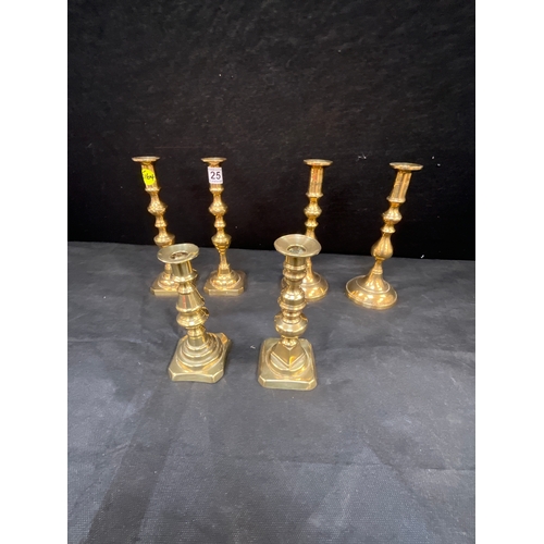 25 - THREE PAIRS OF BRASS CANDLE STICKS