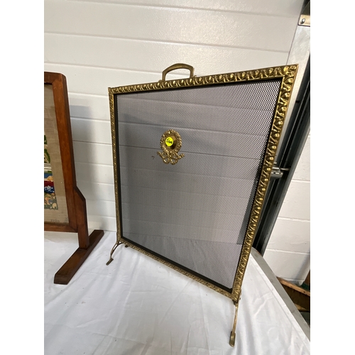 55 - TWO BRASS FIRE GUARDS AND A OAK FRAMED TAPESTRY EXAMPLE-  EXTENDING GUARD SIZE 33”x 23”