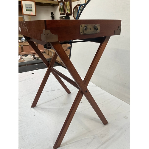 389 - MAHOGANY SERVING TRAY WITH BRASS HANDLES AND FOLDING STAND H29” W23” D23”