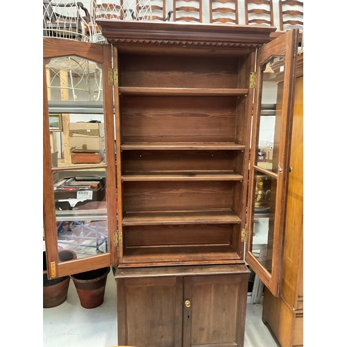 247 - GOTHIC REVIVAL PITCH PINE BOOKCASE WITH 2 GLAZED DOORS TO TOP AND 2 PANELLED DOORS TO BASE H90” W42”... 