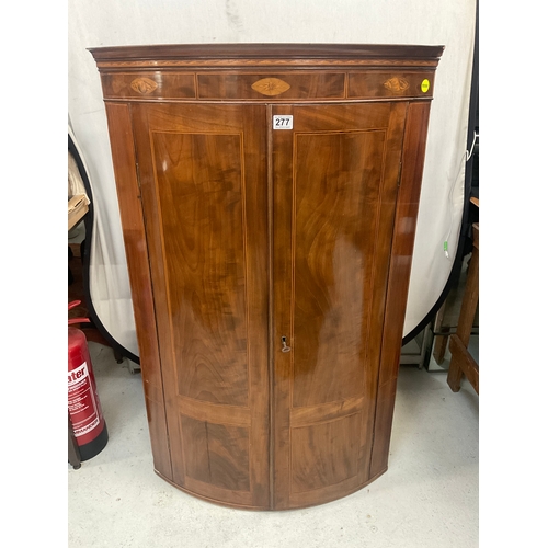 277 - GEORGIAN MAHOGANY INLAID BOW FRONT CORNER CABINET WITH SHELVED INTERIOR AND DRAWER TO BASE H47”W30”D... 