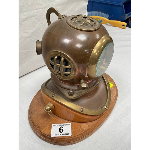 6 - COPPER AND BRASS DIVERS HELMET MANTLE CLOCK (BATTERY) MOUNTED ON WOODEN BASE H8” W10” D6”