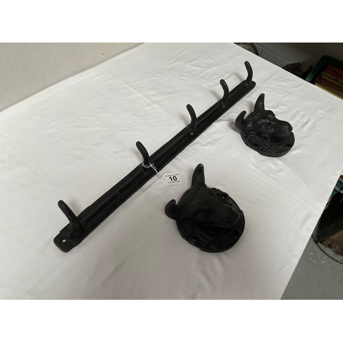 10 - CAST IRON WALL HOOKS W28” AND 2 CAST IRON BULL PLAQUES