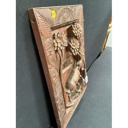 76 - CARVED MAHOGANY PANEL DEPICTING DEER FEEDING IN FOREST MOUNTED IN CARVED MAHOGANY FRAME 23” x 15”