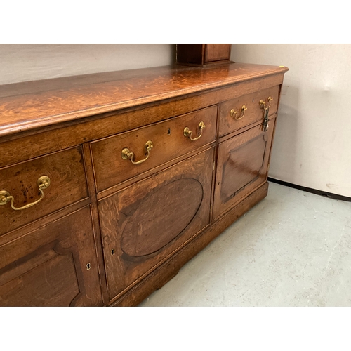 510 - EARLY OAK AND MAHOGANY CROSS BANDED DRESSER WITH OPEN SHELVED RACK TO TOP FLANKED BY 2 DOORS - BASE ... 