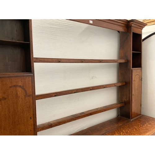 510 - EARLY OAK AND MAHOGANY CROSS BANDED DRESSER WITH OPEN SHELVED RACK TO TOP FLANKED BY 2 DOORS - BASE ... 