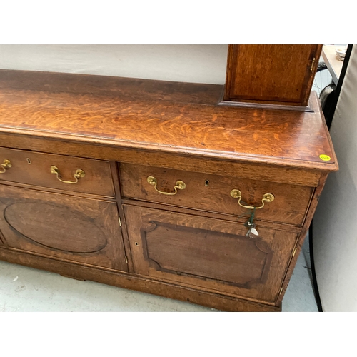 510 - EARLY OAK AND MAHOGANY CROSS BANDED DRESSER WITH OPEN SHELVED RACK TO TOP FLANKED BY 2 DOORS - BASE ... 