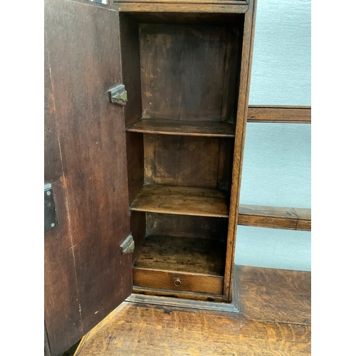 510 - EARLY OAK AND MAHOGANY CROSS BANDED DRESSER WITH OPEN SHELVED RACK TO TOP FLANKED BY 2 DOORS - BASE ... 