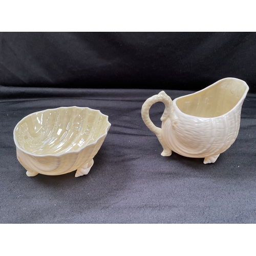 152 - FIVE PIECES OF BELLEEK CHINA TO INCLUDE TWO SHELL PIECES AND FOUR DECORATED PIECES - JUG IS A/F