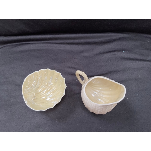 152 - FIVE PIECES OF BELLEEK CHINA TO INCLUDE TWO SHELL PIECES AND FOUR DECORATED PIECES - JUG IS A/F