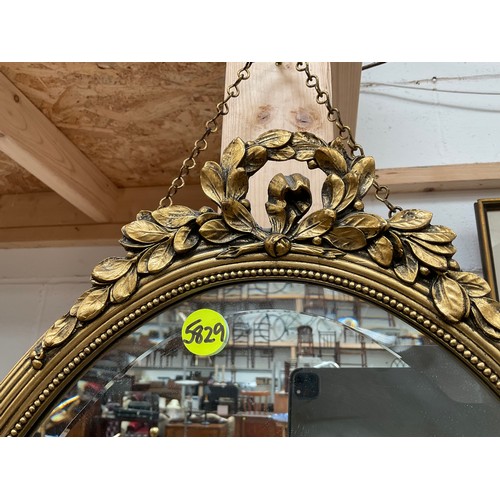 185 - REPRODUCTION DECORATIVE GILT FRAMED OVAL MIRROR 
31” x 18”