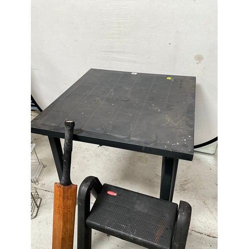 528 - BLACK PLASTIC TABLE ,2 RACKS AND 2 STOOLS