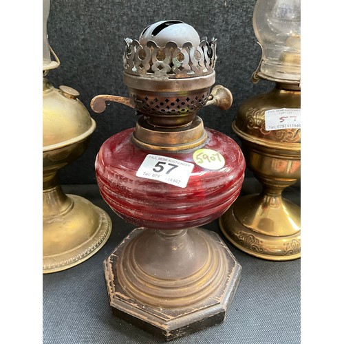 57 - 2 BRASS OIL LAMPS AND VICTORIAN OIL LAMP WITH RED GLASS BOWL