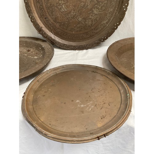 111 - INDIAN BRASS PLAQUE AND THREE BRASS TRAYS