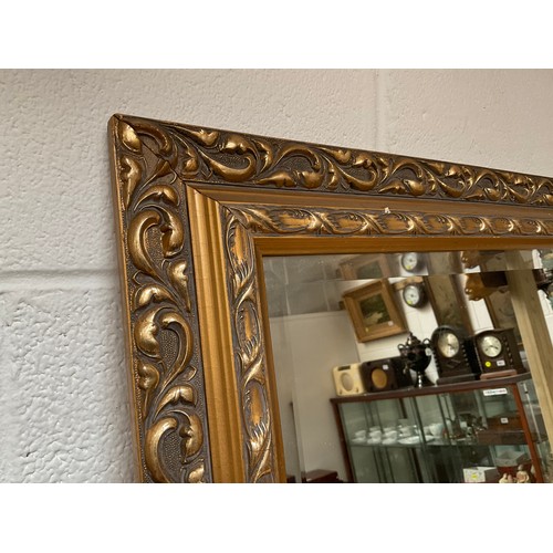 132 - REPRODUCTION GILT FRAMED WALL MIRROR OF LARGE PROPORTIONS 46” x 35”