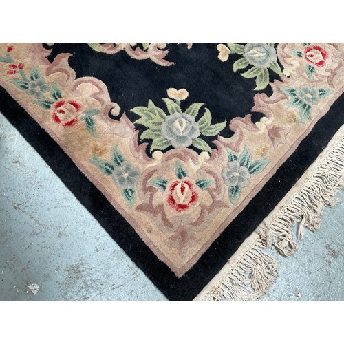 137 - BLACK PATTERNED RUG 38