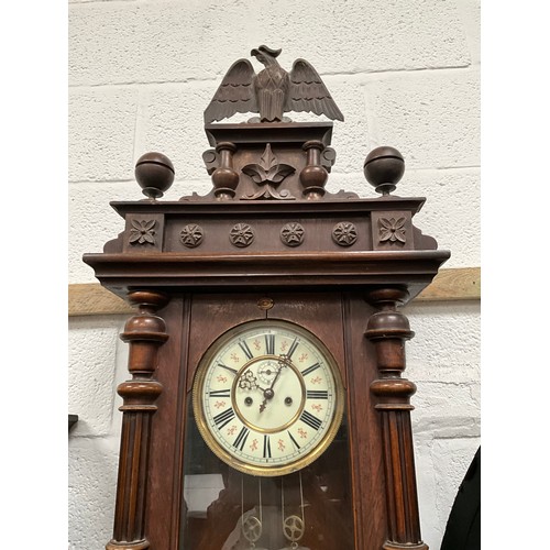 230 - VICTORIAN MAHOGANY TWIN WEIGHT VIENNA WALL CLOCK WITH EAGLE DECORATION TO TOP A/F 
H54” W19” D7”