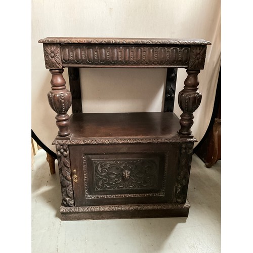 308 - VICTORIAN HEAVILY CARVED OAK SERVING CABINET WITH CARVED PANEL DOOR TO BASE H36” W27” D17”