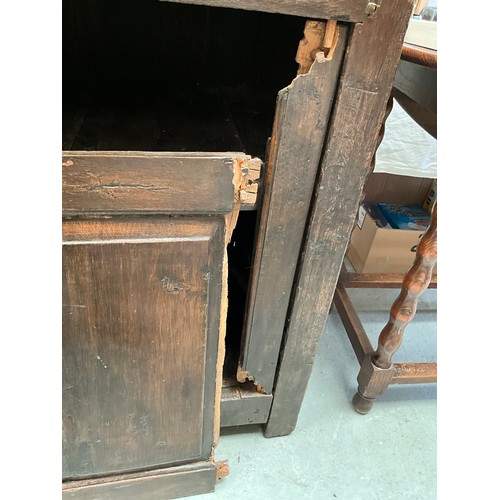 396 - EARLY OAK COURT CUPBOARD DATED 1738 WITH 2 DOORS OVER SINGLE DRAWER AND PANELED DOOR BELOW (BROKEN N... 