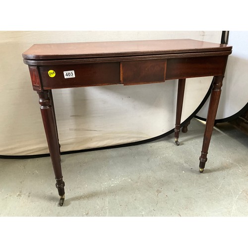 403 - GEORGIAN MAHOGANY FOLDING TEA TABLE ON TURNED LEGS AND ORIGINAL BRASS CASTORS 
H29” W36” D18”