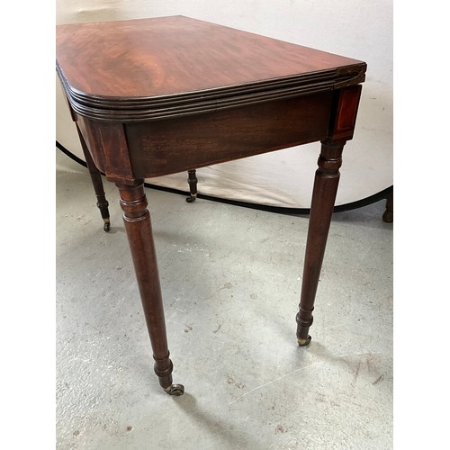 403 - GEORGIAN MAHOGANY FOLDING TEA TABLE ON TURNED LEGS AND ORIGINAL BRASS CASTORS 
H29” W36” D18”