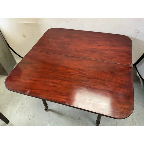 403 - GEORGIAN MAHOGANY FOLDING TEA TABLE ON TURNED LEGS AND ORIGINAL BRASS CASTORS 
H29” W36” D18”