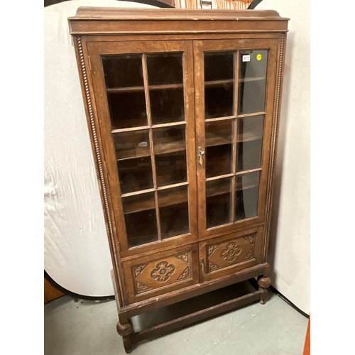 413 - VINTAGE OAK 2 DOOR GLAZED BOOKCASE WITH CARVED PANELS H73” W39” D16”