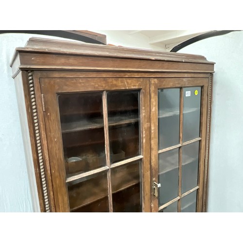 413 - VINTAGE OAK 2 DOOR GLAZED BOOKCASE WITH CARVED PANELS H73” W39” D16”