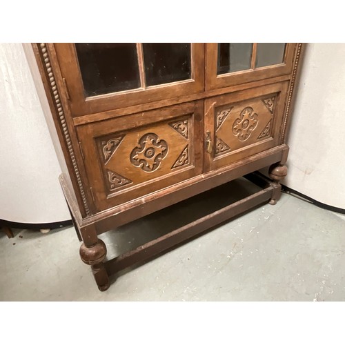 413 - VINTAGE OAK 2 DOOR GLAZED BOOKCASE WITH CARVED PANELS H73” W39” D16”